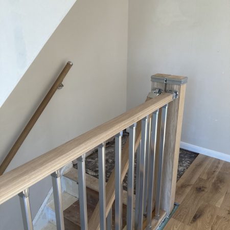 Solution Chrome Stair Parts with an Oak Double Newel Post