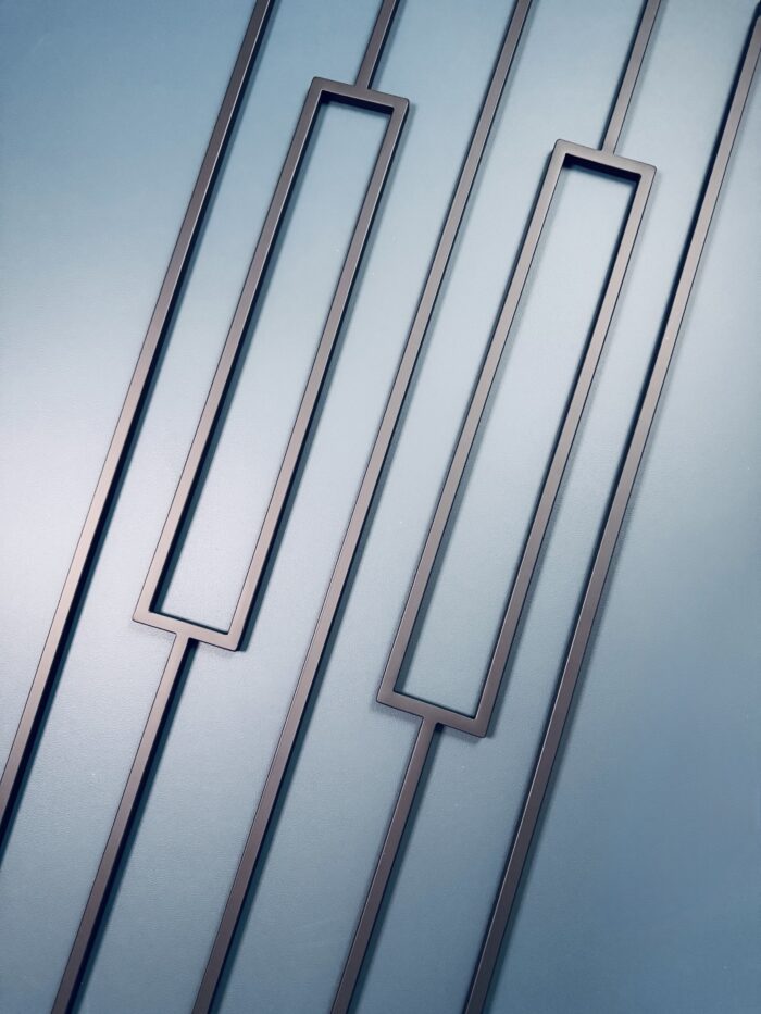 black rectangle and square metal spindles