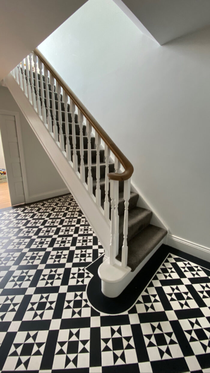 White staircase with black handrail
